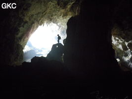 A contre-jour, un puissant pilier stalagmitique occupe la galerie de l'entrée supérieure de la grotte de Shuidong 水洞 (Qiannan 黔南, Pingtang 平塘, Guizhou 贵州省, Chine).